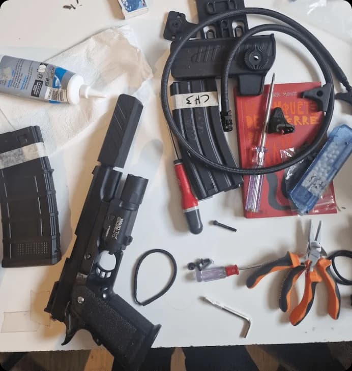 Airsoft internals and tools laid out on the workbench